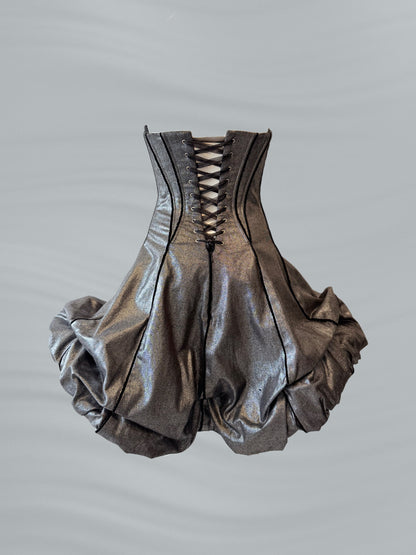 Metallic silver corset-style garment on a gray background