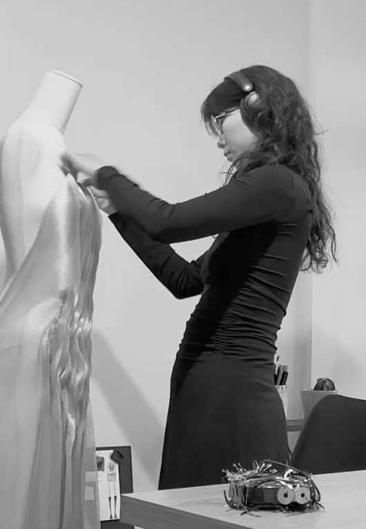 Nandin Erdene working on a dress